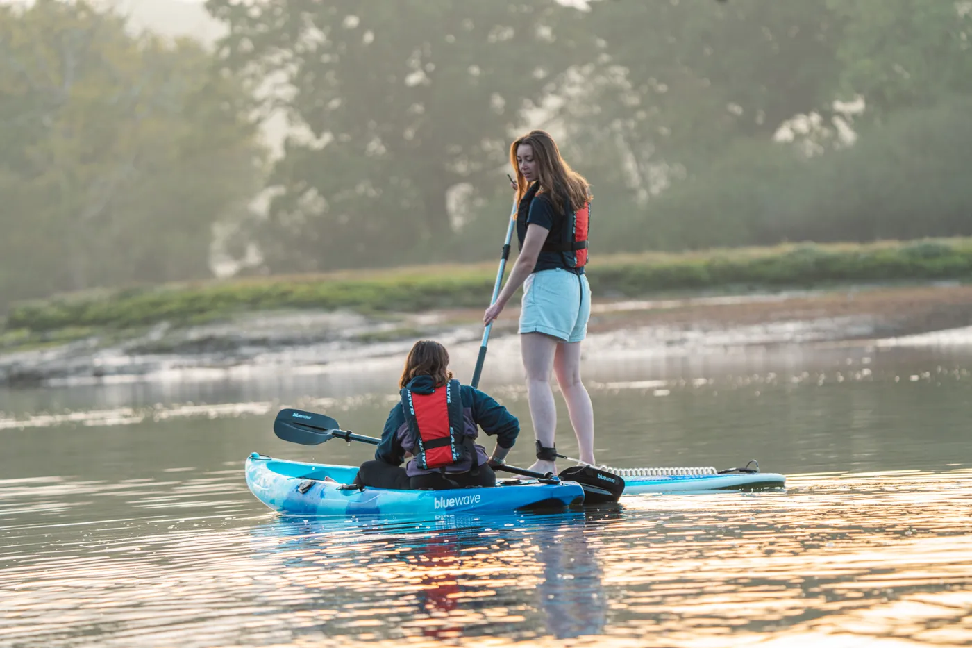 Family enjoying paddleboarding adventure - Yak Shack partnership locations