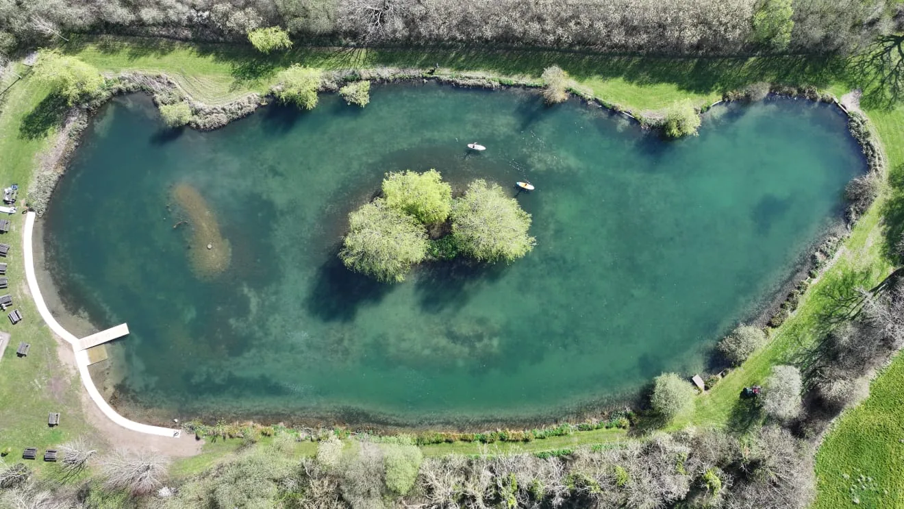 Aerial drone view of Litton Lakes, Dorset, with crystal-clear water