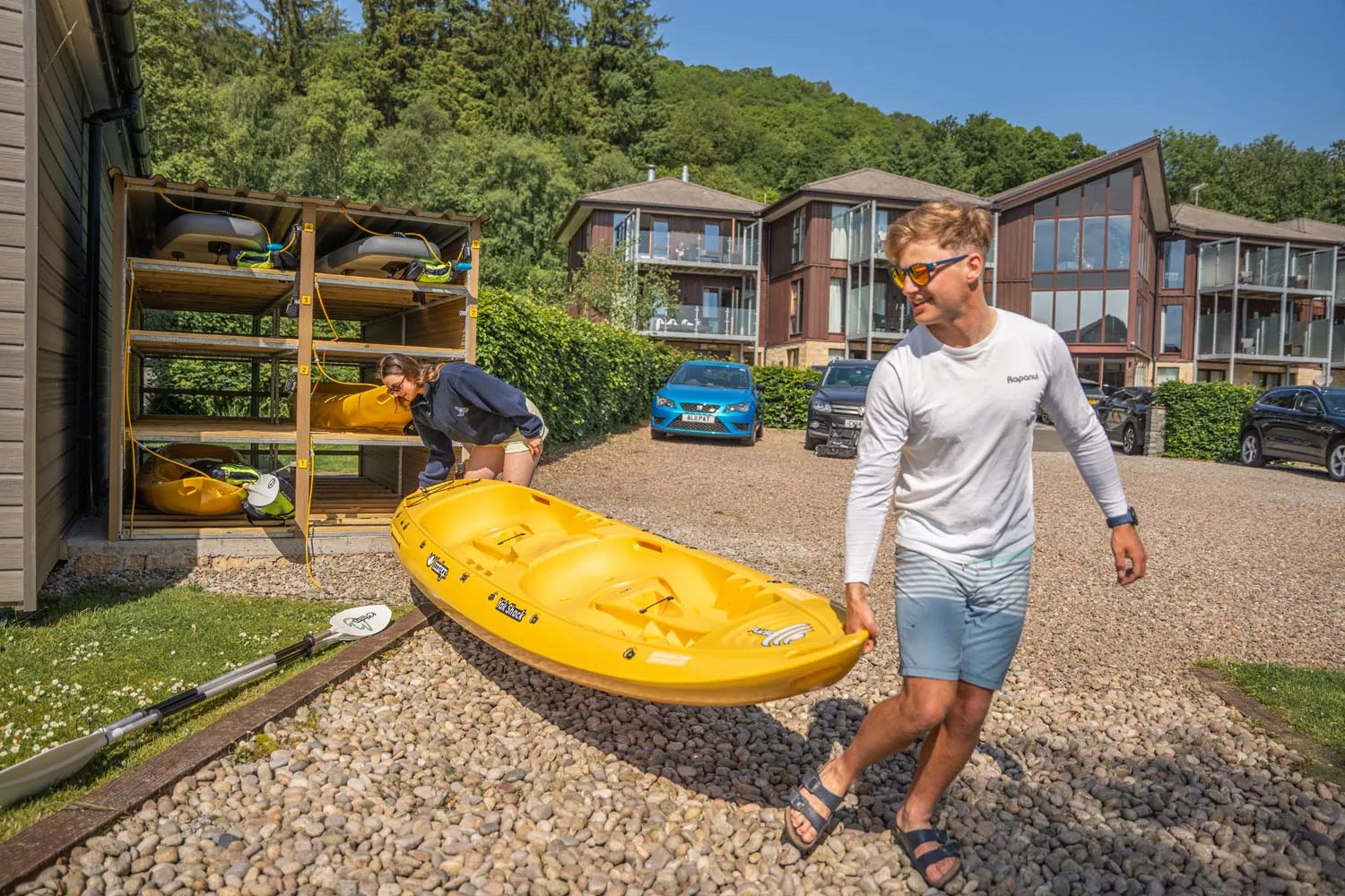 Carrying a Yak Shack kayak from the rental unit at Loch Lomond