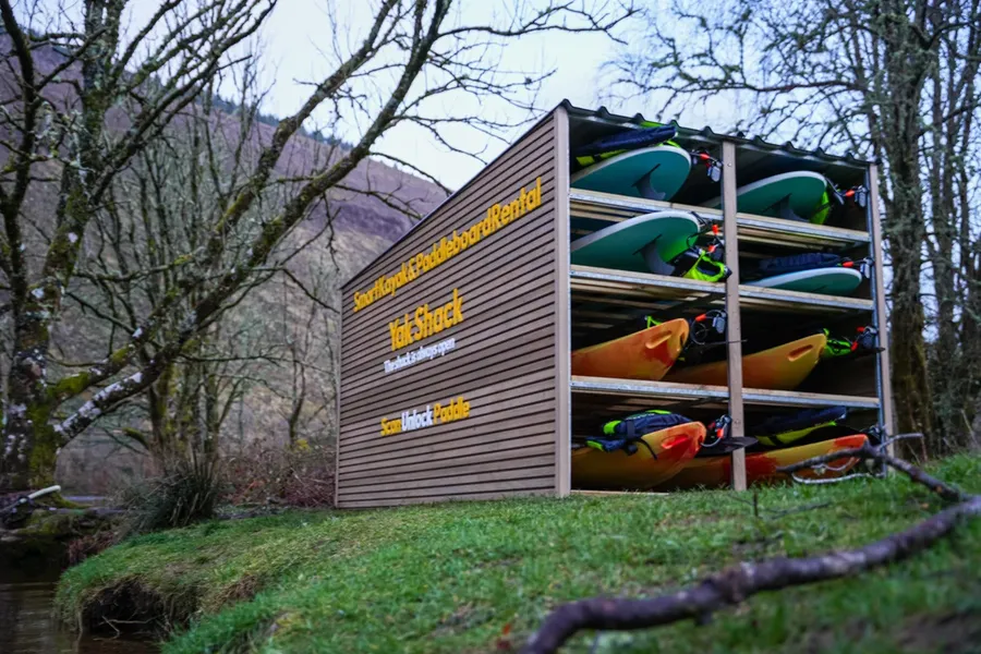 Kayaks and paddleboards racked at Loch Oich Yak Shack