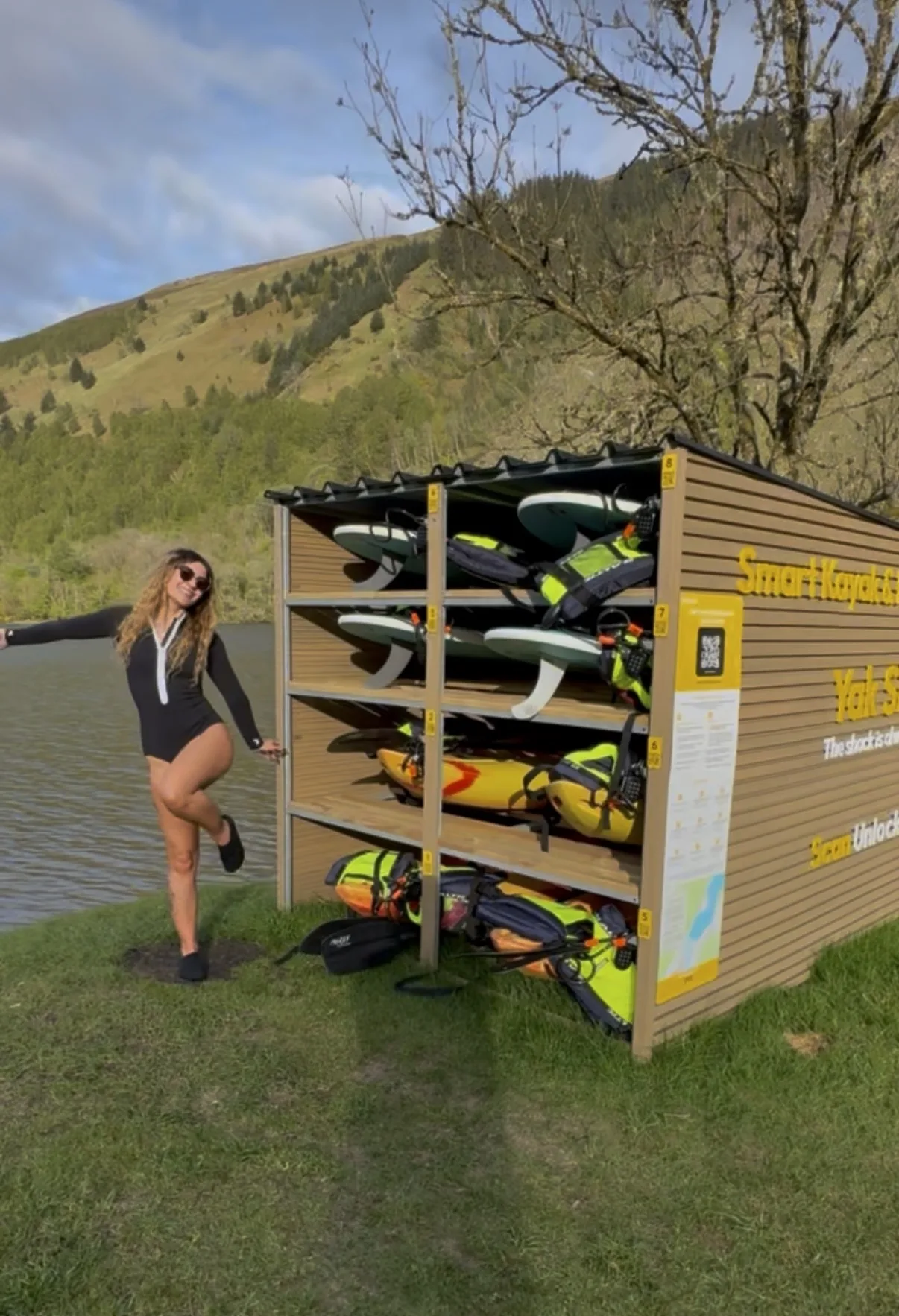 Woman posing at the Yak Shack smart hire unit on the banks of Loch Oich in the Scottish Highlands